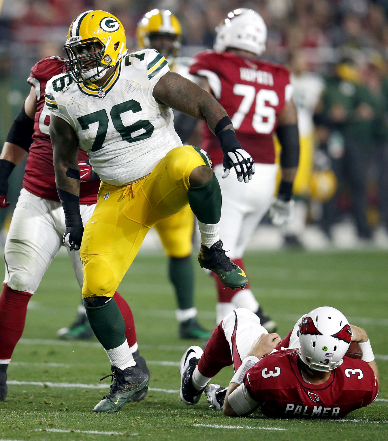 Mike Daniels sacks Carson Palmer, AP photo